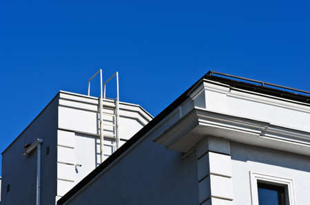 White staircase to the roof of the house against the blue skyの写真素材