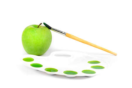 Painted apple green paint with a paletteの写真素材
