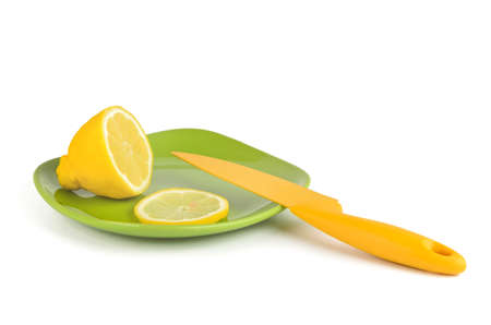Lemon yellow and knife on green plateの写真素材