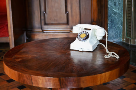 White, vintage phone on a round tableのeditorial素材