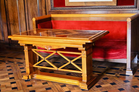 Antique table and a sofa with a red clothのeditorial素材