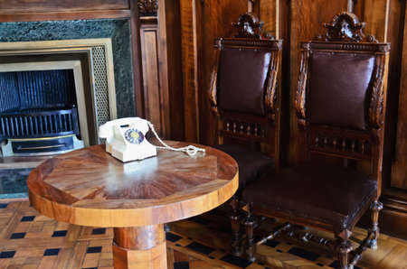 White, vintage phone on a round tableの写真素材