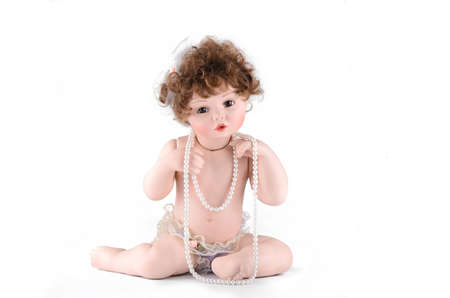 Porcelain doll with pearl beads on a white backgroundの写真素材