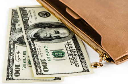 Two hundred dollars and a purse on a white backgroundの写真素材