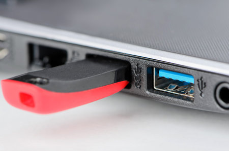 Grey laptop, usb and red flash memory