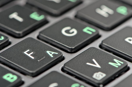 Black keyboard of silver laptop close-up