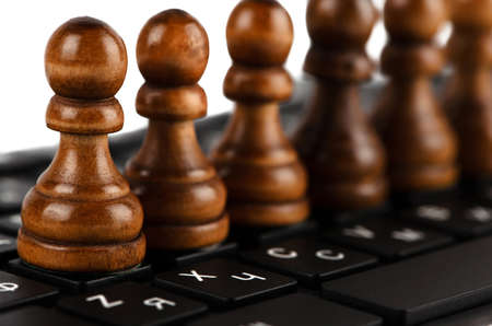 Group of black pawns on the keyboard closeupの写真素材