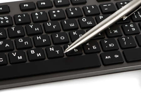 Element of black keyboard with white letters and penの写真素材