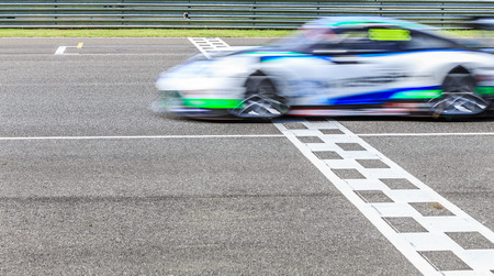 Race car crossing the finish line on a circuitの写真素材