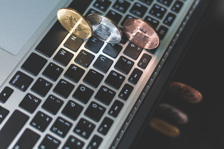 Coins of cryptocurrency or Bitcoin lying over laptop keyboard,  Business concept of worldwide cryptocurrency, Bitcoin trading concept, Laptop with Bitcoin, Cryptocurrency and banking concept.の写真素材