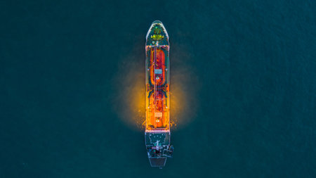 Aerial view oil and gas chemical tanker in open sea at night, Refinery Industry cargo ship.