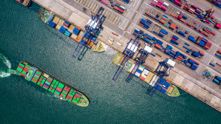 Container ship loading and unloading in deep sea port, Aerial top view of logistic import export...