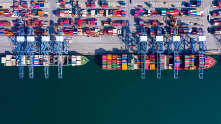 Aerial view container cargo ship freight shipping unloading at original destination port with quay...