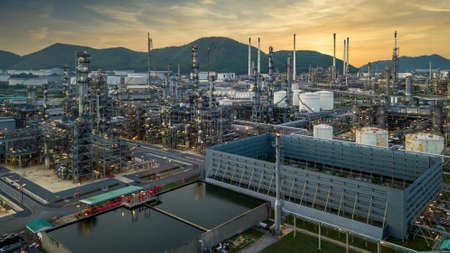 Oilâ refineryâ with oil storage tank and petrochemicalâ plant industrial background at twilight, Aerial view oil and gas refinery at twilight.の写真素材