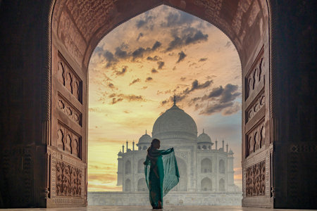 Woman in traditonal culture dress saree or sari in the Taj Mahal, India, Taj Mahal is most beautiful white marble mausoleum in the India city, Agra, Uttar Pradesh, Taj Mahal, India.の写真素材