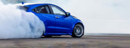 Car drifting diffusion race drift car with lots of smoke from burning tires on speed track, Professional driver drifting car with lots of white smoke .の写真素材