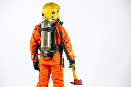 Fireman fire fighter with axe on white background, Rescue firefighter man fireman, Firefighter fireman wearing full equipment, oxygen mask and an axe.の写真素材