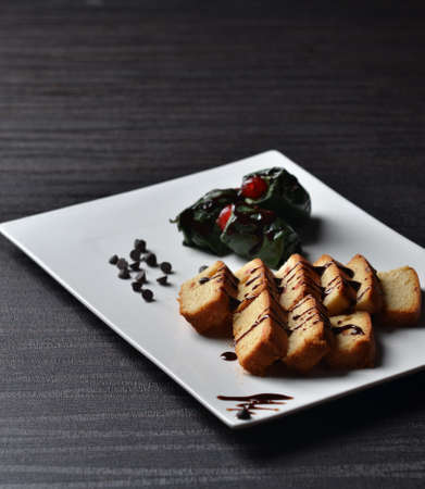 a milk cake and chocolate pan on white trayの写真素材