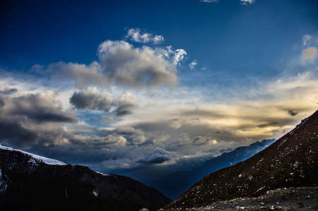a beautiful view with cold clouds and soft sun light mountainsの写真素材