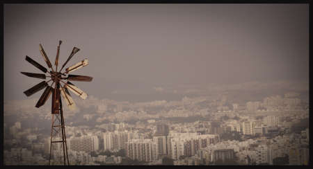 wind mill with city scene in day lightの写真素材