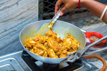 chef cooking chicken in kitchenの写真素材