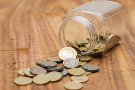 coins spilling out of glass jar