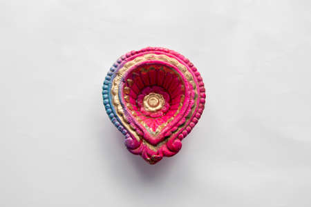 Colorful clay diya lamps lit during diwali celebrationの写真素材