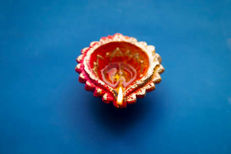 Colorful clay diya lamps lit during diwali celebrationの写真素材