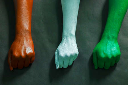 three hands are painted with three colors,saffron,white and green to represent tricolor Indian national flag.15 August Independence day India.celebration of freedom.symbol of brotherhood.の写真素材