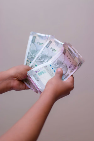 selective focus counting Indian five hundred rupees currency notes.