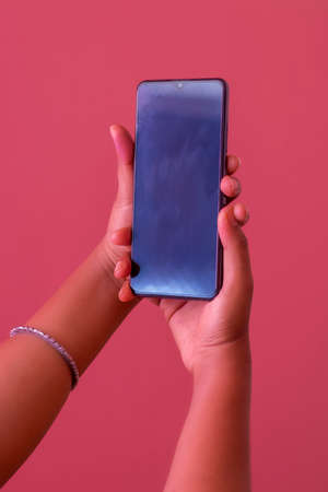 selective focus of mobile phone holding by hand.の写真素材
