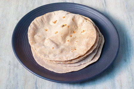 Quesadilla bread on a blue plate on a wooden table
