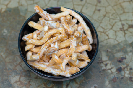 Bowl of churros on the table. Top view.
