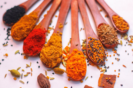 Spices and herbs in wooden spoons. Food and cuisine ingredients.
