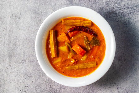 Vegetable curry in a white bowl on a gray background.の写真素材
