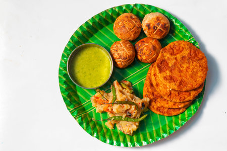 indian traditional food on a plate with green chutney.
