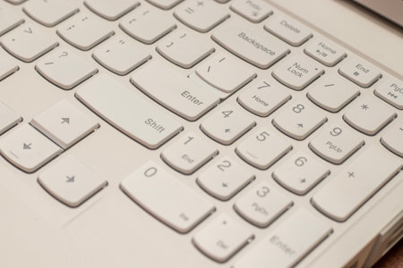 Close up of white laptop keyboard with selective focus and shallow depth of fieldの写真素材