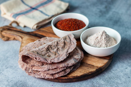 healthy super food ragi roti with raw ragi and flour. selective focus.