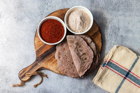 healthy super food ragi roti with raw ragi and flour. selective focus.
