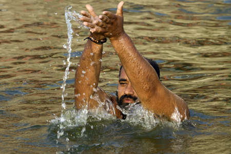 Varanasi, Uttarpradesh, India, April 1 2011:people wash themselves in the river Ganga in the holy city of Varanasi. The holy ritual of washing is held every day のeditorial素材