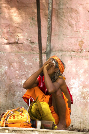 Varanasi, Uttarpradesh, India, April 1 2011:sadhu (holy man) smokes a pipe in ghats of varanasi