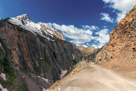 Road through colorful Mountains of mighty Zozila pass above eleven thousand feet in Himalayan Mountains, Ladakh, Jammu and Kashmir, Indiaの写真素材