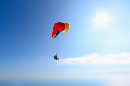 Paragliding in Bulgaria over the mountains against clear blue skyの写真素材