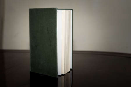 green book half-open side on black backgroundの写真素材