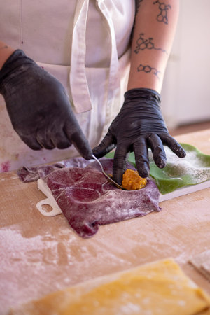 person preparing pasta on a tableの写真素材