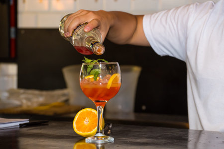 bartender preparing fruit cocktail in a bar