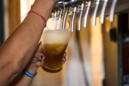 person serving craft beer in a glassの写真素材