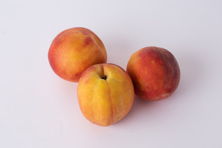 fresh peaches on a white mezaの写真素材