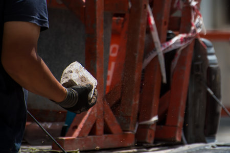 construction worker moving stone debris by hand