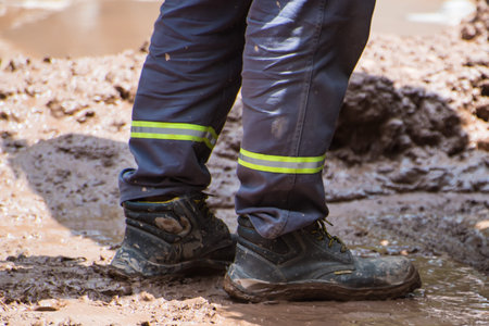 construction worker standing on a muddy street